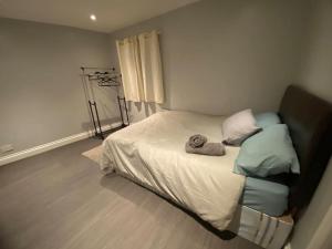 a bedroom with a bed with two pillows on it at Spacious 2 bedroom flat london in London