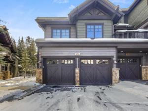 a house with two garage doors in the snow at 35A Union Creek Townhomes West townhouse in Copper Mountain