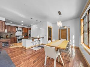 a kitchen and dining room with a wooden table and chairs at 35A Union Creek Townhomes West townhouse in Copper Mountain