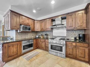 a kitchen with wooden cabinets and stainless steel appliances at 35A Union Creek Townhomes West townhouse in Copper Mountain