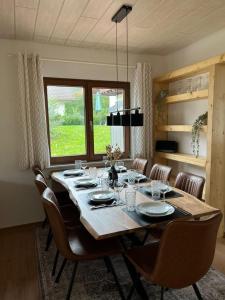 a large dining room table with chairs and a large window at Ferienhaus Seepark Kirchheim in Kirchheim +25 photos