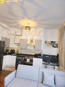 a living room with a couch and a kitchen at Charming flat in Stokes Croft in Bristol