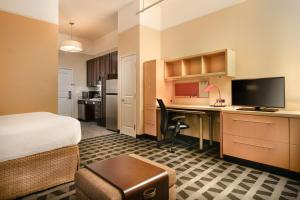 a hotel room with a bed and a desk with a computer at TownePlace Suites by Marriott Houston Westchase in Houston