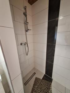 a bathroom with a shower with a glass door at Domki Nad Liliowym Stawem in Berezka +23 photos