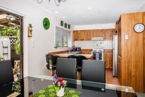 a kitchen with a table and chairs and a counter top at Denby Crest in Whangarei
