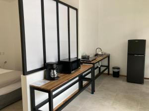 a room with a table with a coffee maker on it at Rancho Capulin B&B in Tárcoles