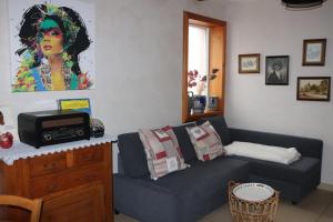 sala de estar con sofá y microondas en Appartement ' Le Lupulus', en Bilwisheim