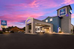 a building with a car garage with a sunset at Clarion Pointe Sevierville-Pigeon Forge in Sevierville