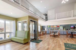 a living room with a green chair and a table at Quality Inn in Lebanon