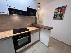 a kitchen with a stove and a counter top at Studio Bellepierre in Saint-Denis