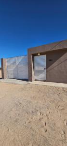 a building with two garage doors on the side of it at Sofia apartment in Puerto Peñasco