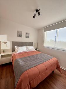 a bedroom with a large bed and a window at Caldera Apartment in Caldera