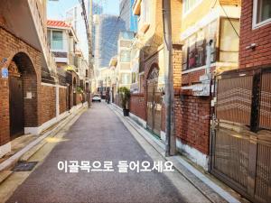an empty alleyway between buildings in an asian city at Gongdeok Stay Masil in Seoul