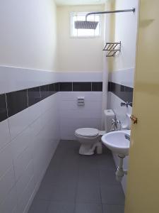 a bathroom with a toilet and a sink at Afya Alya Guesthouse Melaka in Melaka