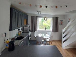 a kitchen with a table and chairs in a room at 78 Atlantic Reach in Newquay