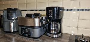 a coffeemaker and a coffee maker on a counter at Eric Wilkins Apartments in Kampala