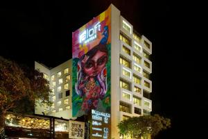 a building with a painting on the side of it at Aloft Lima Miraflores in Lima