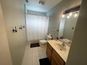 a bathroom with a shower and a toilet and a sink at Fabulous 4BR only 1.5 blocks to the beach! in Wildwood