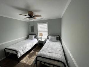 - une chambre avec 2 lits et un ventilateur de plafond dans l'établissement Fabulous 4BR only 1.5 blocks to the beach!, à Wildwood