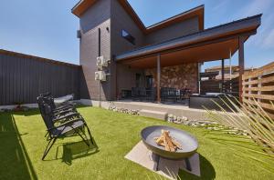 a backyard with a fire pit and a house at Resoreat Takashima in Imazu