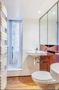 a bathroom with a toilet and a sink at Chic Parisian Flat in Paris