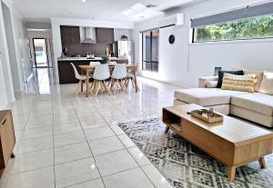 a living room with a couch and a table at Townhouse on Greybox in Kialla