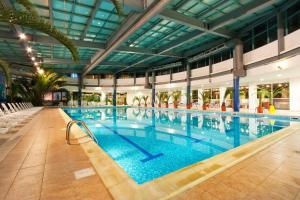 a large swimming pool in a large building at Rila Hotel Borovets in Borovets