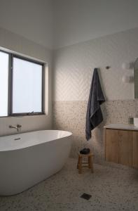 a bathroom with a large white tub and a sink at The McKinlay Echuca in Echuca