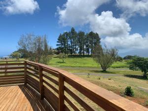 a wooden fence with a view of a field at Puunui Lodge in Vairao