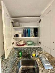 a kitchen counter with a sink in a kitchen at Nice 2 Twin bedroom - Best central location in Miami - We have Drop off Service and Laundry for free!!!! in Miami