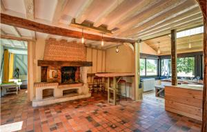 an open kitchen with a fireplace in a house at Pet Friendly Home In Fontaine-la-louvet With Outdoor Swimming Pool in Thiberville