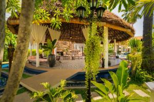 a resort with a pavilion with a table and chairs at The Embassy Angkor Resort & Spa in Siem Reap