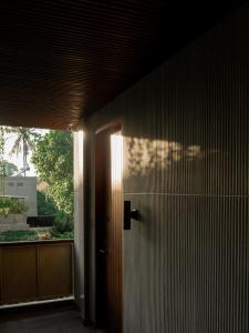 a door to a room with a window and a building at ARTOTEL Haniman Ubud in Ubud