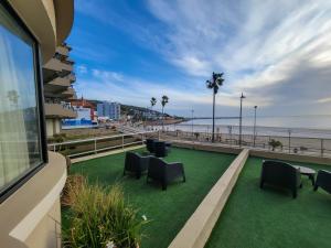 a view of the beach from the balcony of a building at Hotel Genoves in Piriápolis