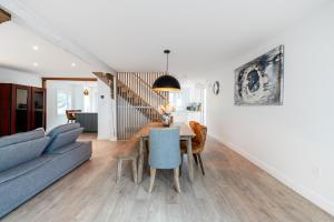a living room with a blue couch and a table at lacbrome Chalet lake+Terrasse+BBQ+Hot-tub in Lac-Brome