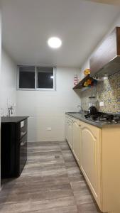 a kitchen with yellow cabinets and a counter top at El Morro Beach 2 in Santa Marta