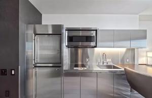 a kitchen with stainless steel appliances and a microwave at Luxury Hotel Suite With Private Strip View Balcony in Las Vegas