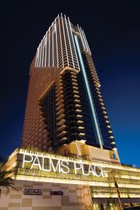 a tall building with a sign on the side of it at Luxury Hotel Suite With Private Strip View Balcony in Las Vegas