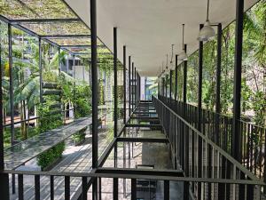 a glass walkway in a building with plants at St Mary Residences Jalan Tengah in Kuala Lumpur