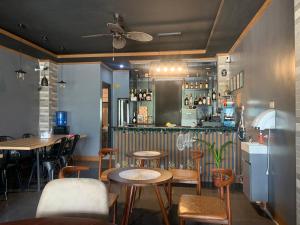 a restaurant with tables and chairs and a bar at ZL TRAVELERS INN in Batuan
