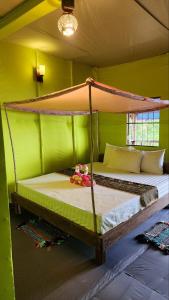 a bedroom with a bunk bed in a green room at Sweet Jungle Bungalows in Koh Rong Island