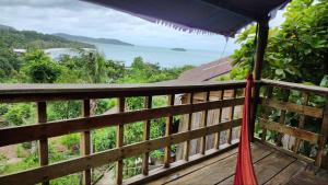 a balcony with a view of the ocean at Sweet Jungle Bungalows in Koh Rong Island