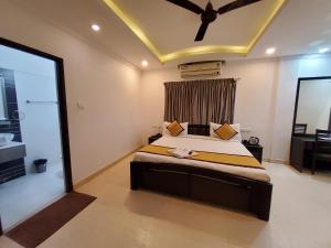 a bedroom with a bed and a large window at Skyry Residency in Chennai