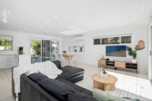 a living room with a couch and a table at Mermaid Beach Retreat in Gold Coast