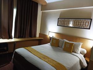 Krevet ili kreveti u jedinici u okviru objekta Tamarin Hotel Jakarta manage by Vib Hospitality Management