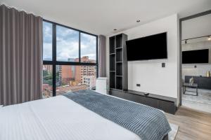 Postel nebo postele na pokoji v ubytování Apartamentos HOUSY Laureles