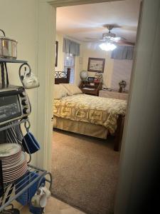 a bedroom with a bed and a room with a table at Charleston, SC themed - PRIVATE 1 QUEEN BED 1 BATH APARTMENT 2 FUTONS THAT FOLD OUT FLAT TO SLEEP ON & LEATHER LOVE SEAT GAS LOGS IN LIVING ROOM FULL KITCHEN POKER BUMPER POOL TABLE CONVENIENTLY LOCATED IN COLUMBIA SOUTH CAROLINA 1 QUEEN BED & 2 SOFA BEDS in Columbia