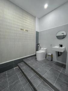 a bathroom with a toilet and a sink at River Hotel 5 in Long Xuyên