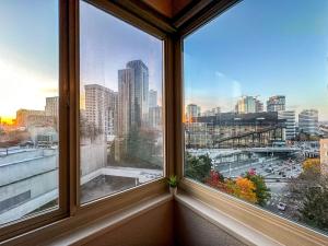 a window with a view of a city skyline at 2BR Downtown Convention Center Near Attractions in Seattle