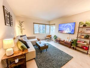 a living room with a couch and a tv at 2BR Downtown Convention Center Near Attractions in Seattle